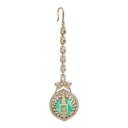 Gold-plated American Diamond maang tikka with an emerald-green center stone and circular pendant for bridal and festive wear.