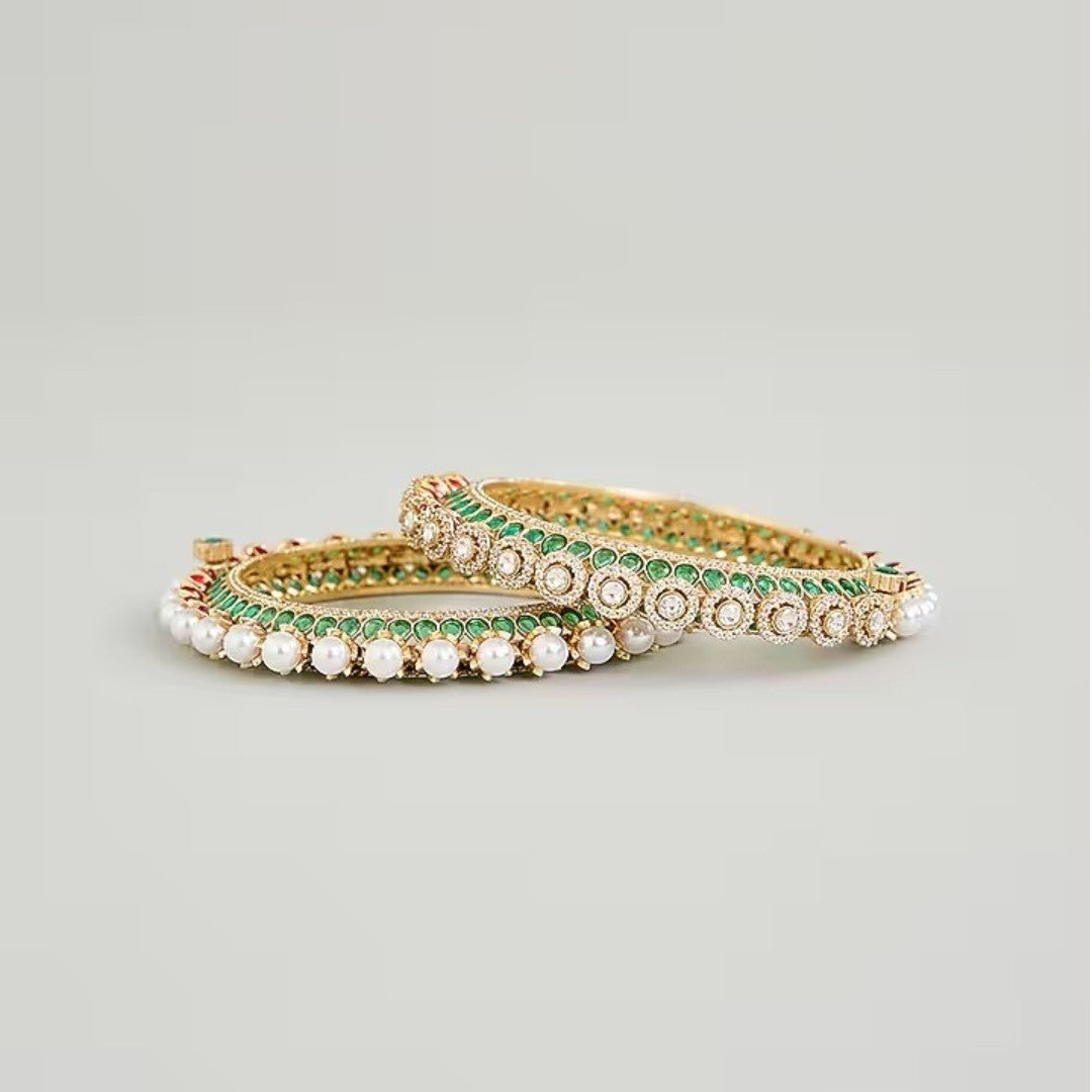 Gold-plated green Kundan bangles with pearl border and sparkling white stones for women.