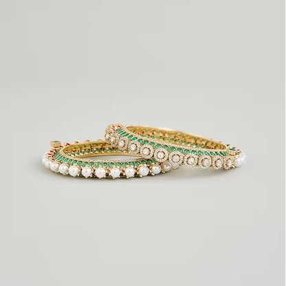 Gold-plated green Kundan bangles with pearl border and sparkling white stones for women.