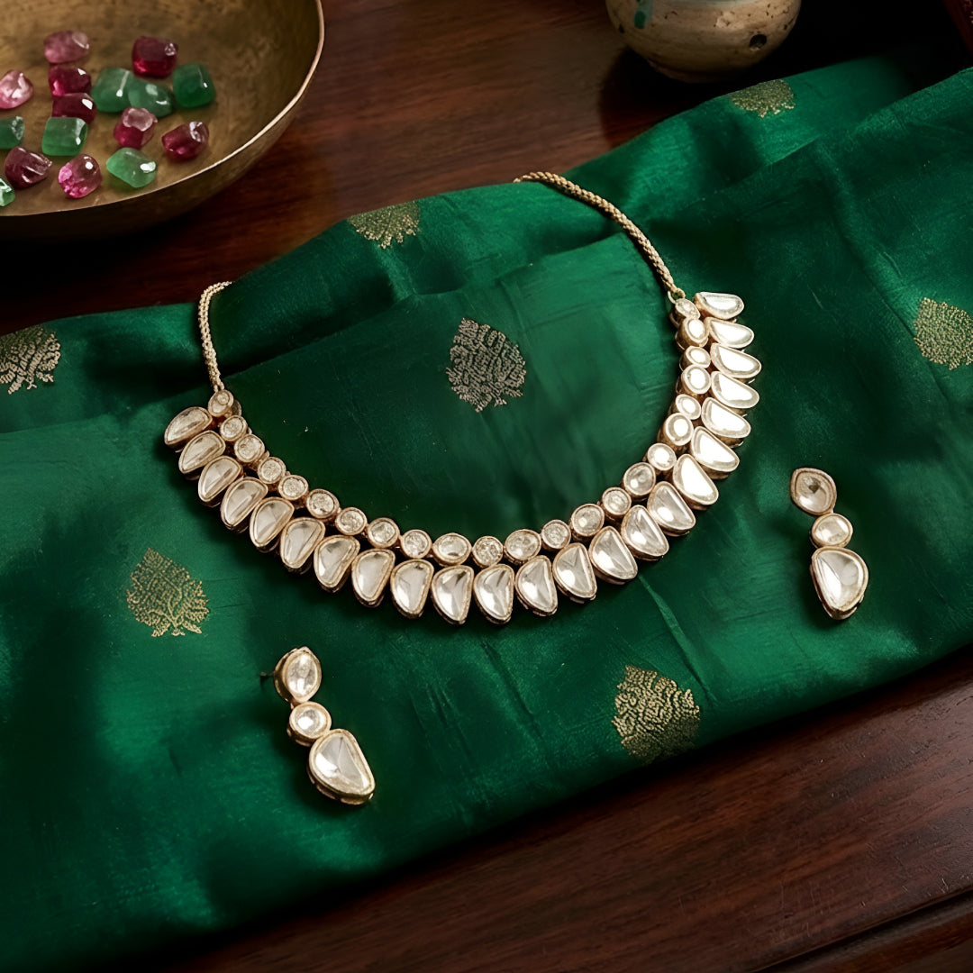 Luxury gold-tone Kundan statement necklace with clear uncut stones in an elegant crescent design for bridal and wedding jewelry.