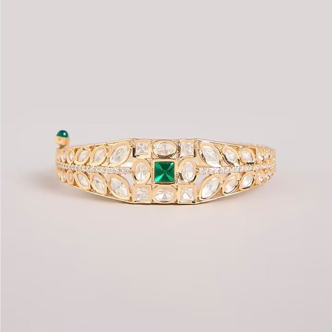 Green stone AD studded gold tone designer kada bracelet with intricate leaf detailing