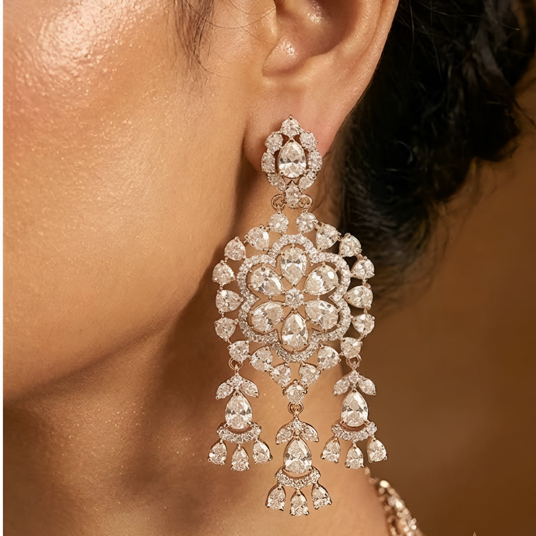 Gold-tone Kundan floral necklace set featuring a statement pendant with dangling accents and matching drop earrings on a white background.