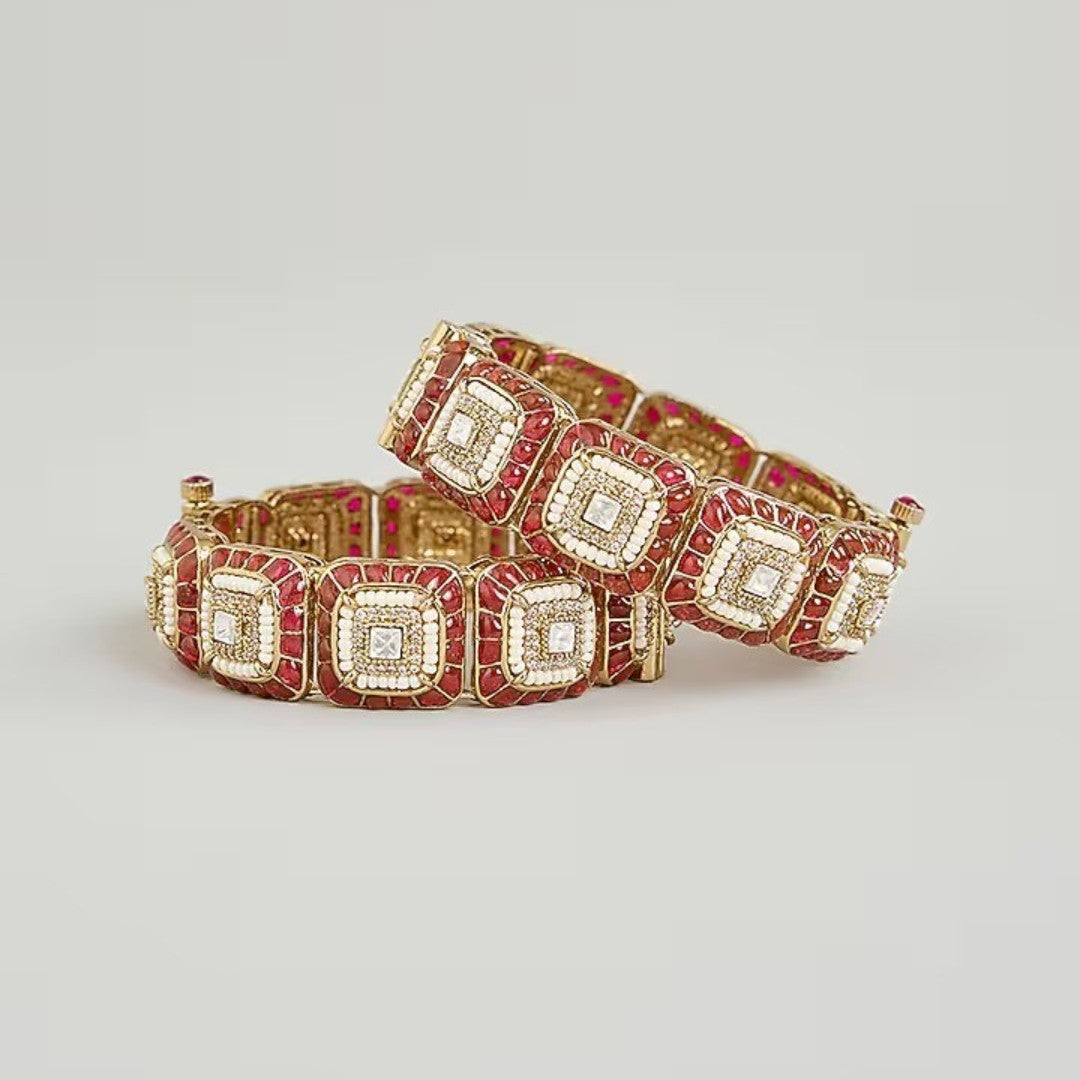 Gold-plated designer kada bangles with ruby-red stones and white crystal square motifs for women.