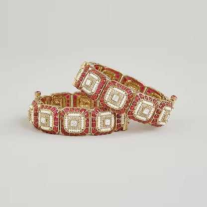 Gold-plated designer kada bangles with ruby-red stones and white crystal square motifs for women.