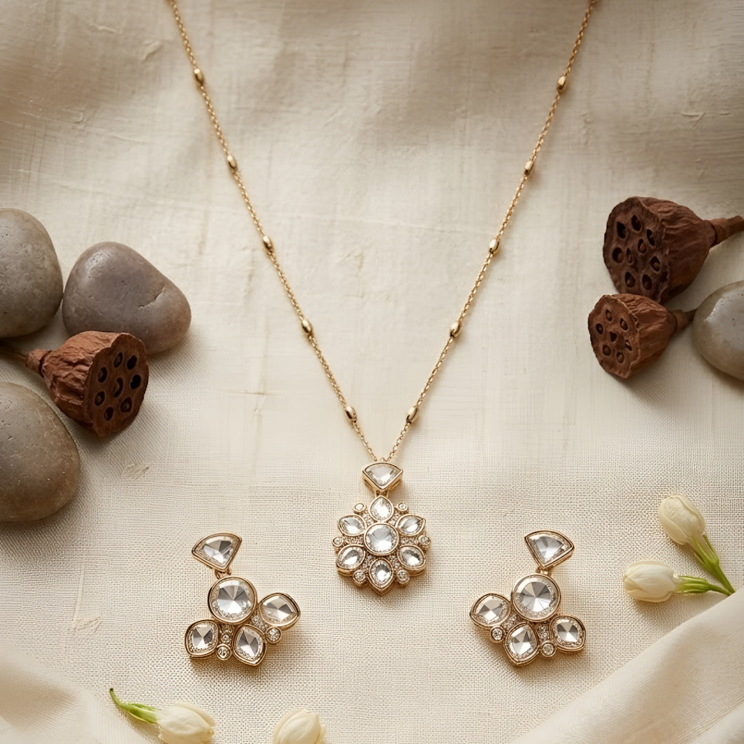 Gold-tone floral crystal pendant necklace with matching crystal earrings jewelry set featuring sparkling clear stones and elegant flower design.