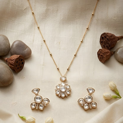 Gold-tone floral crystal pendant necklace with matching crystal earrings jewelry set featuring sparkling clear stones and elegant flower design.