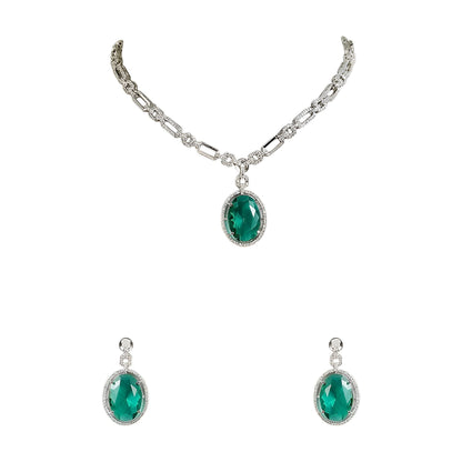Silver-toned necklace set featuring an emerald green oval crystal pendant with matching drop earrings on a white background.