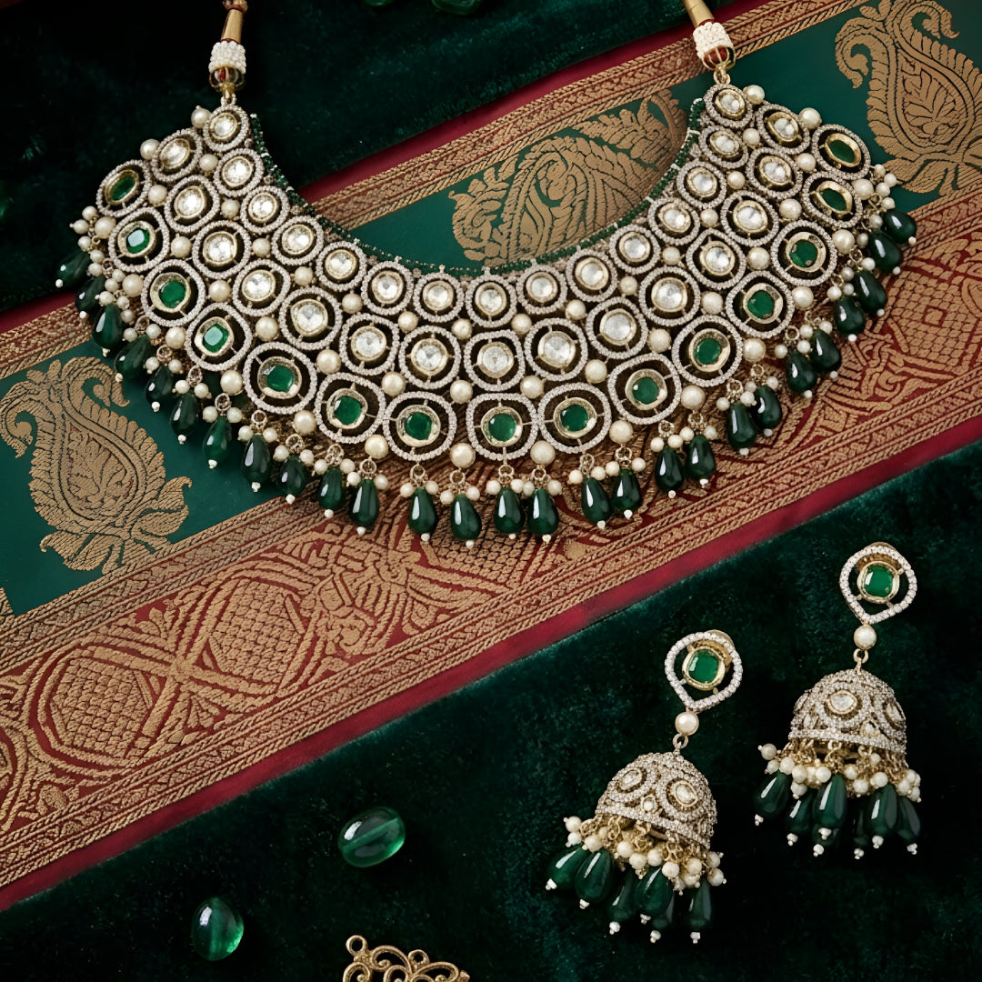 Traditional green Kundan choker necklace set with Polki stones, pearl detailing, green bead drops, and matching jhumka earrings for bridal and wedding wear.