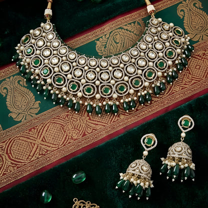 Traditional green Kundan choker necklace set with Polki stones, pearl detailing, green bead drops, and matching jhumka earrings for bridal and wedding wear.