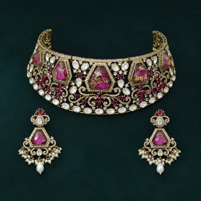 Royal pink Kundan bridal choker necklace set with matching earrings featuring white Kundan stones, floral detailing, pink statement stones, and pearl drop accents.