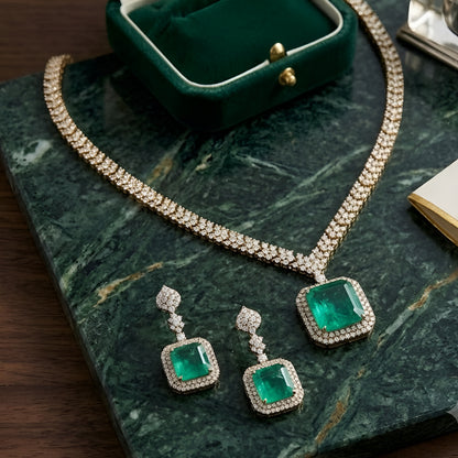 Elegant emerald green crystal pendant necklace set with sparkling zircon-studded chain and matching drop earrings in a gold-tone finish.