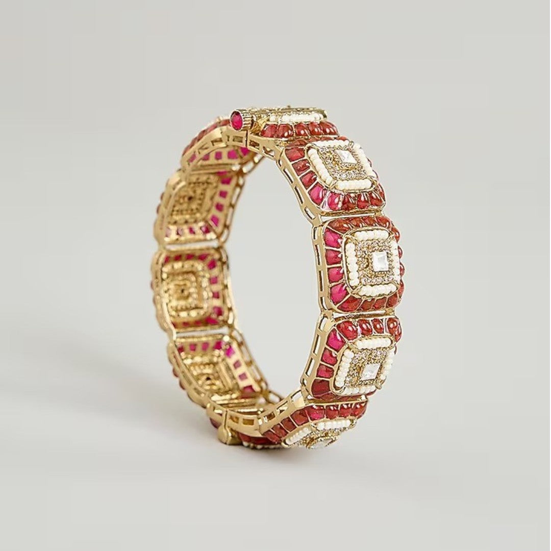 Gold-plated designer kada bangles with ruby-red stones and white crystal square motifs for women.