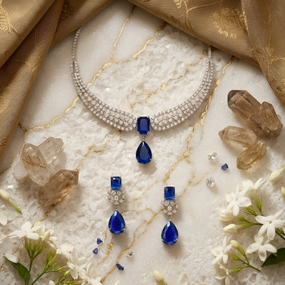 Elegant blue sapphire crystal choker necklace set with zircon-studded silver finish and matching drop earrings for women.