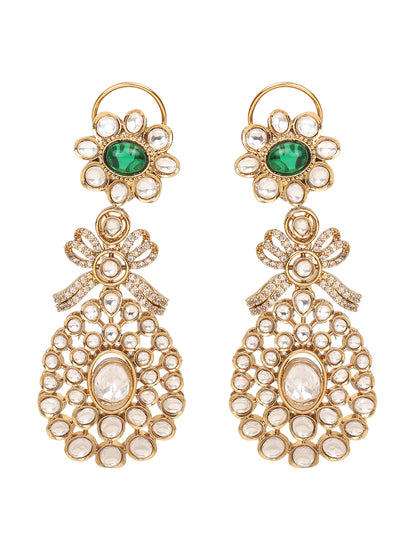 Gold-toned necklace with a braided cord and adjustable tassel tie, featuring intricate white stone detailing with oval green gemstones and multiple dangling teardrop motifs, paired with matching drop earrings, displayed on a plain light background.