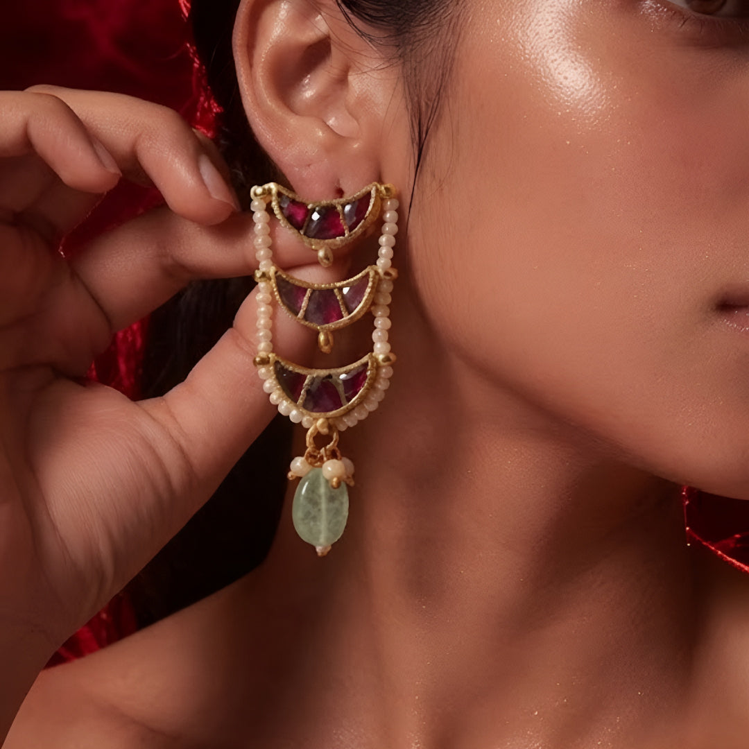 "Layered Kundan choker necklace and earring set in maroon gold with pearl and green bead drops, bridal jewellery styled on model"