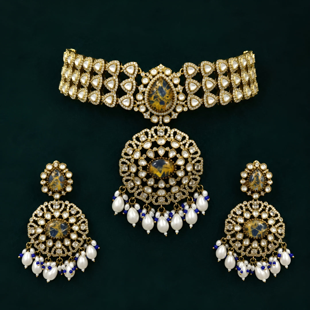 Royal blue stone Kundan choker necklace set with matching statement earrings featuring white Kundan stones, blue center stones, and pearl drop detailing.