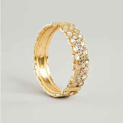 Gold-plated Kundan bangles with teardrop stones and pearl bead detailing for women, ideal for bridal and festive wear.