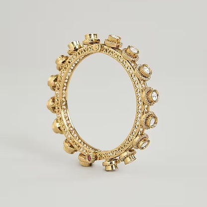 Gold-plated Kundan bangles with round white stone detailing for women, ideal for weddings and festive wear.