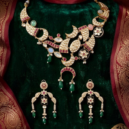Designer gold-plated kundan necklace set with floral enamel motifs, pink stone accents, sparkling white kundan work, green bead drops, and matching statement earrings.