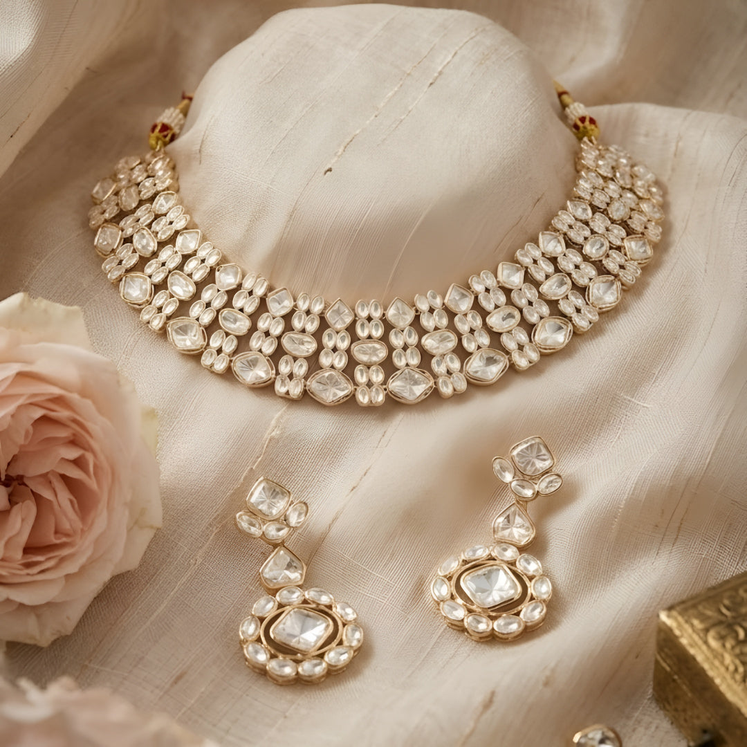 Gold-tone Kundan choker necklace set with matching earrings featuring white uncut-style stones, ideal for bridal, wedding, and festive wear.