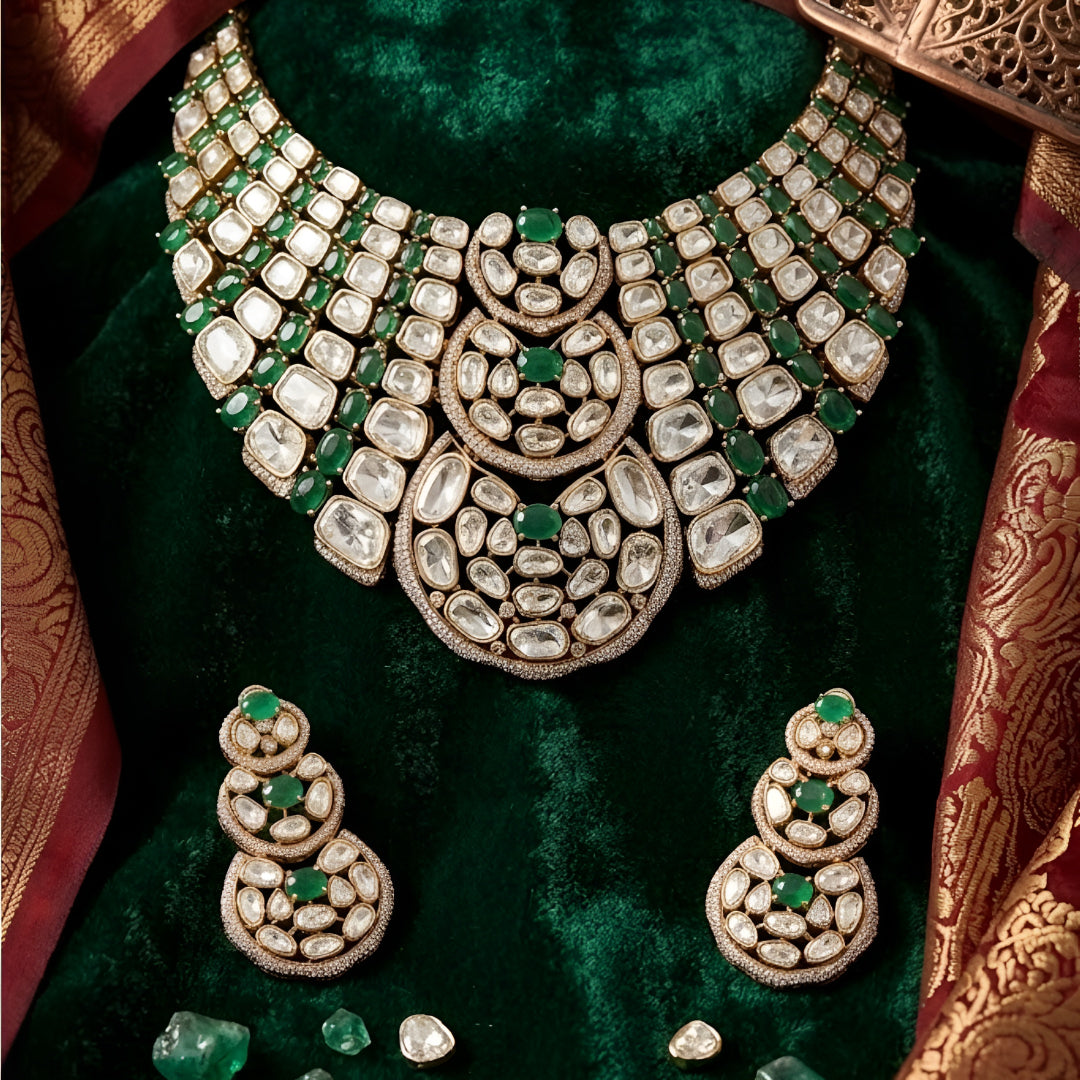Luxury Kundan Polki necklace set with matching earrings featuring uncut Polki diamonds, green emerald accents, and traditional bridal jewelry craftsmanship in a gold finish.