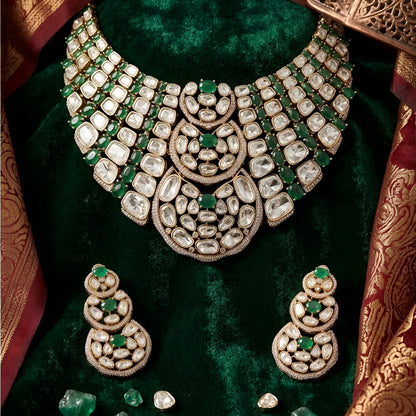 Luxury Kundan Polki necklace set with matching earrings featuring uncut Polki diamonds, green emerald accents, and traditional bridal jewelry craftsmanship in a gold finish.