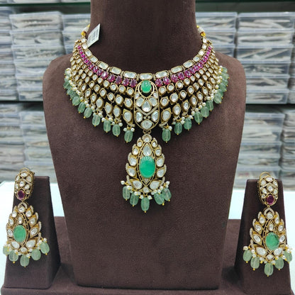 Luxury Green Kundan Bridal Choker Necklace Set with Ruby Stones, Pearl Drops, and Matching Earrings for Wedding and Traditional Wear.