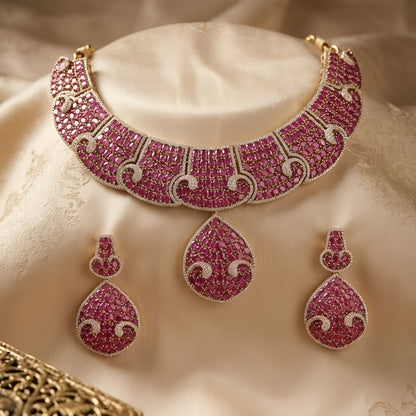 Luxury ruby pink crystal statement choker necklace set with teardrop pendant and matching earrings for weddings and festive occasions.