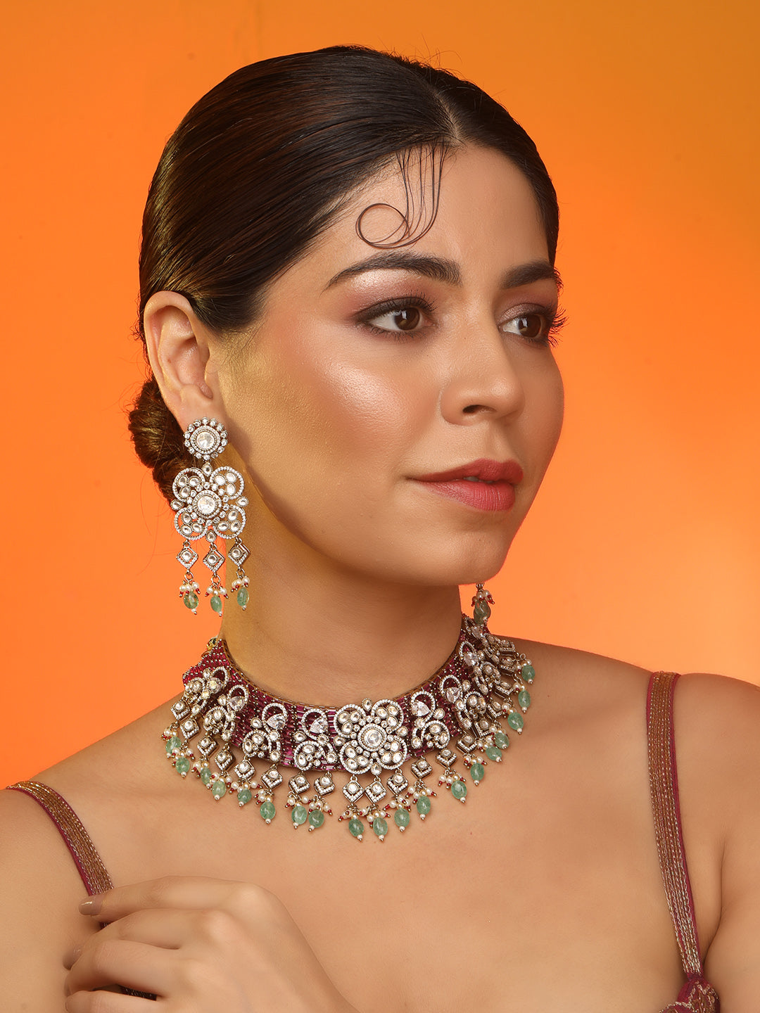 Kundan bridal necklace set with pink stones, green bead drops, and matching statement earrings in gold tone