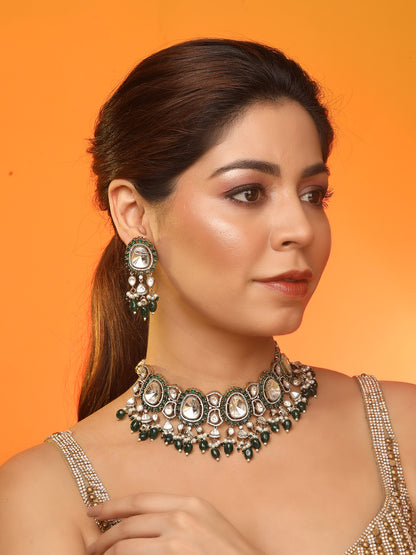 Elegant gold-tone choker necklace set with large mirror-polished stones, green bead accents, and pearl detailing, paired with matching dangling earrings