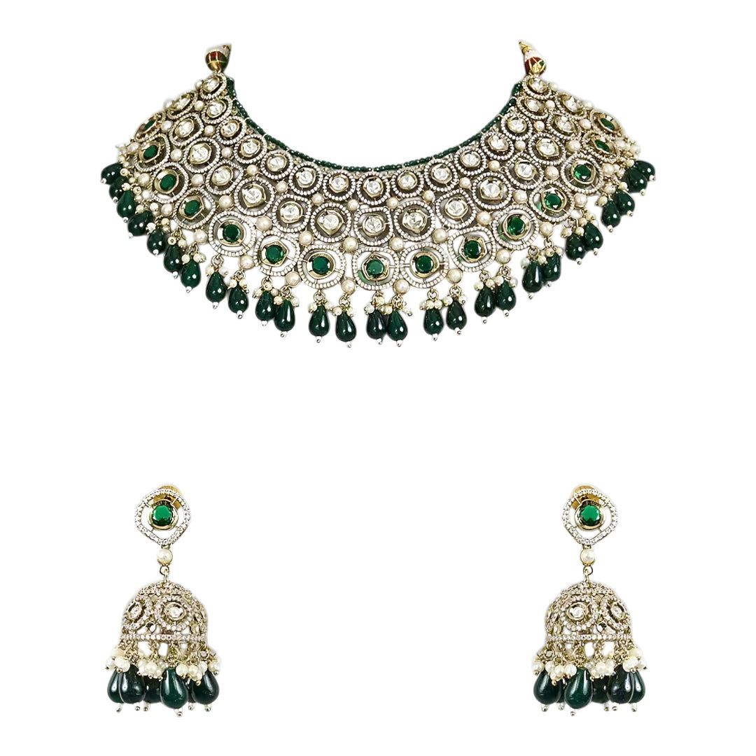 Traditional green Kundan choker necklace set with Polki stones, pearl detailing, green bead drops, and matching jhumka earrings for bridal and wedding wear.