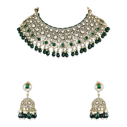Traditional green Kundan choker necklace set with Polki stones, pearl detailing, green bead drops, and matching jhumka earrings for bridal and wedding wear.