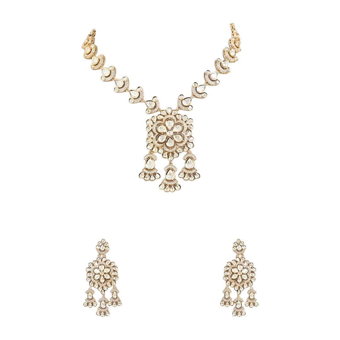Gold-tone Kundan floral necklace set featuring a statement pendant with dangling accents and matching drop earrings on a white background.