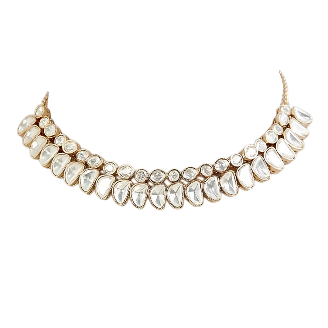 Luxury gold-tone Kundan statement necklace with clear uncut stones in an elegant crescent design for bridal and wedding jewelry.