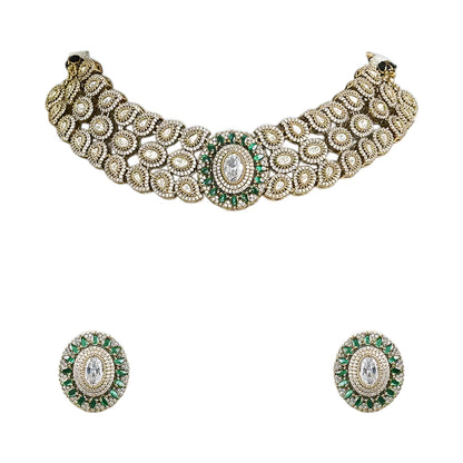 Elegant diamond and emerald choker necklace set with matching stud earrings featuring intricate floral motifs, sparkling white stones, green gemstone accents, and a luxurious gold-tone finish.