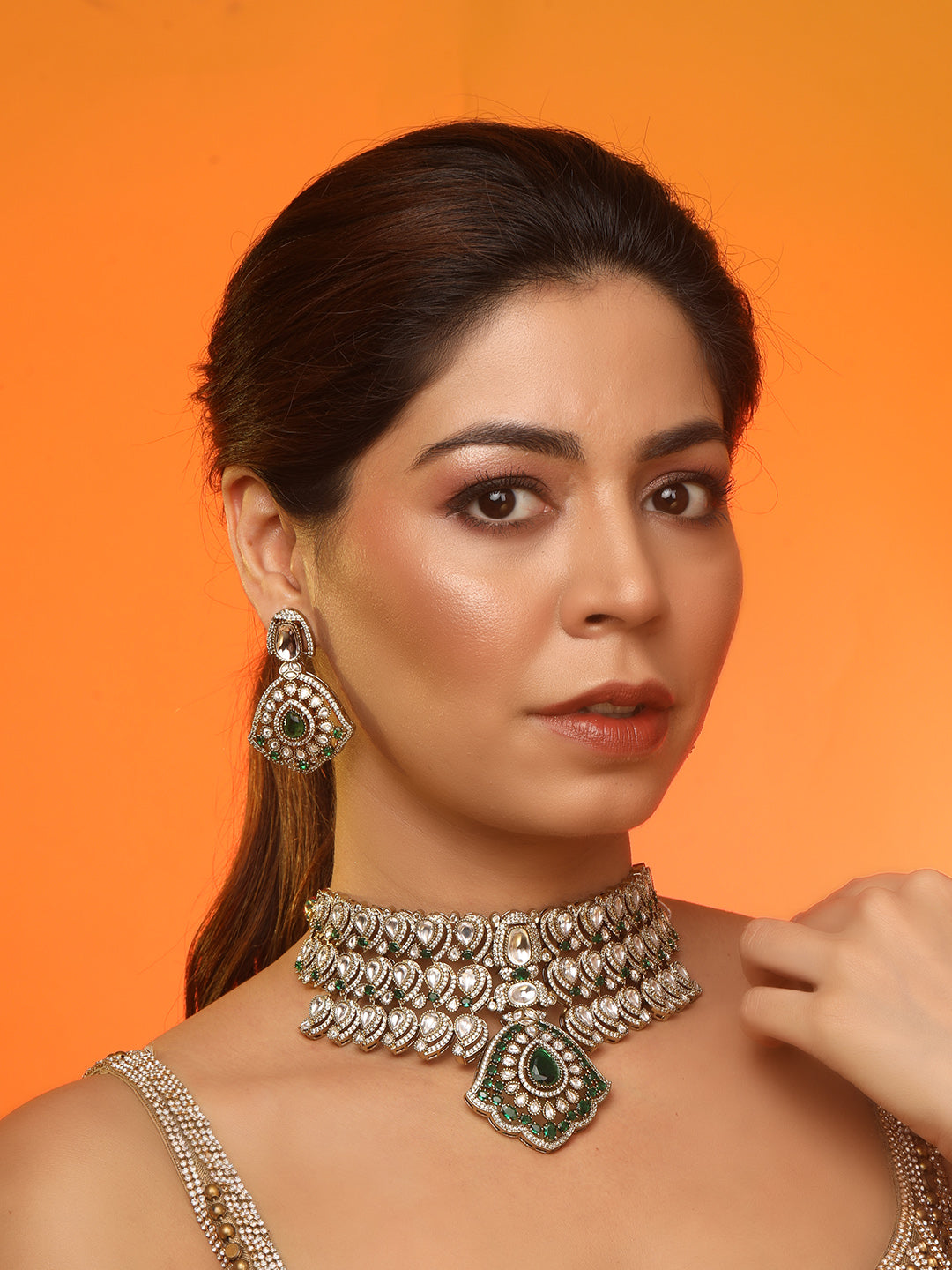 Traditional Kundan choker necklace set with green stones and matching earrings