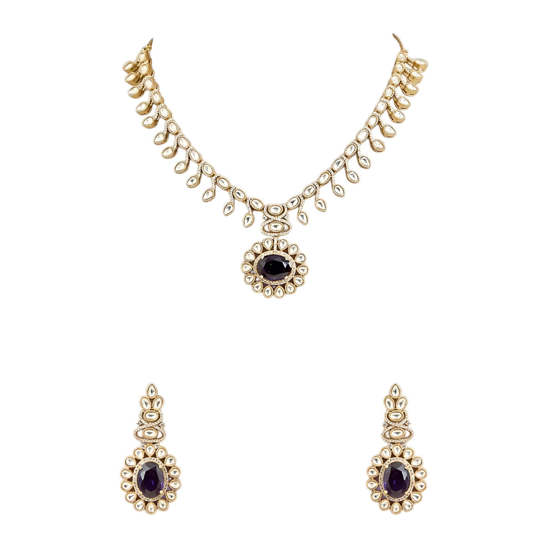 Gold-tone Kundan-inspired necklace and earrings set featuring white stones and deep purple oval gemstone accents in an elegant traditional design.