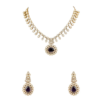 Gold-tone Kundan-inspired necklace and earrings set featuring white stones and deep purple oval gemstone accents in an elegant traditional design.