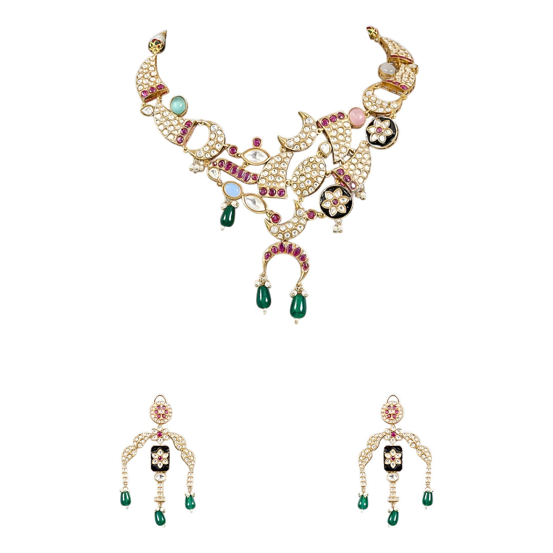 Designer gold-plated kundan necklace set with floral enamel motifs, pink stone accents, sparkling white kundan work, green bead drops, and matching statement earrings.