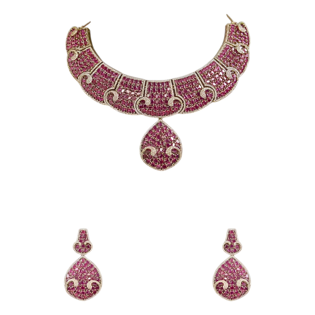 Luxury ruby pink crystal statement choker necklace set with teardrop pendant and matching earrings for weddings and festive occasions.