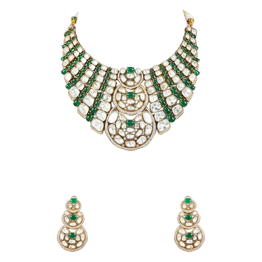 Luxury Kundan Polki necklace set with matching earrings featuring uncut Polki diamonds, green emerald accents, and traditional bridal jewelry craftsmanship in a gold finish.