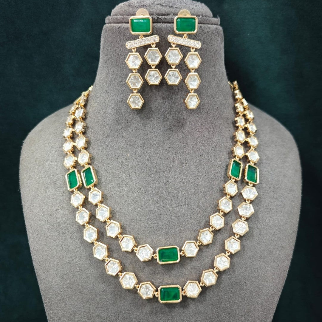Gold-plated double-layer Kundan necklace set featuring emerald green rectangular stones, Polki-style hexagonal stones, and matching drop earrings for women.