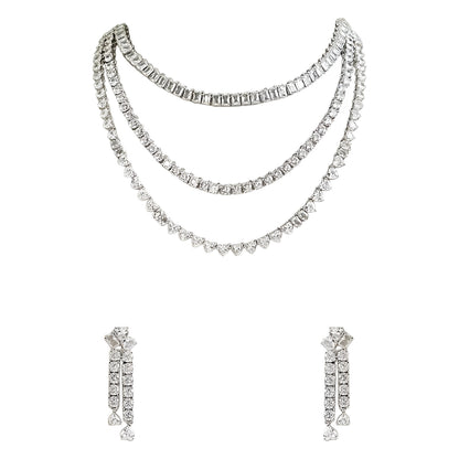 Silver-tone layered crystal necklace with matching drop earrings featuring sparkling clear stones in an elegant bridal jewelry design.