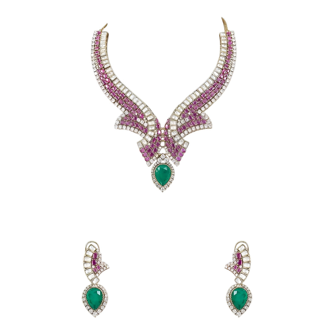 Luxury emerald, ruby and diamond necklace set with matching earrings in white gold featuring pear-shaped emerald gemstones, pink ruby accents and sparkling diamond detailing.