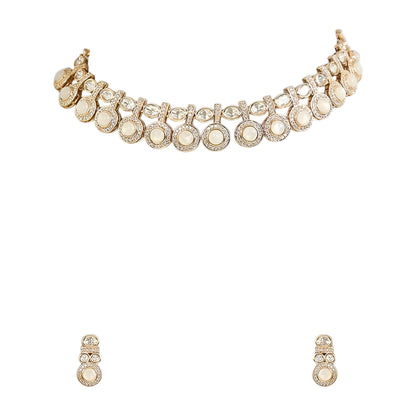 Gold-tone statement necklace set with ivory cabochon stones, crystal embellishments, and matching earrings on white background.