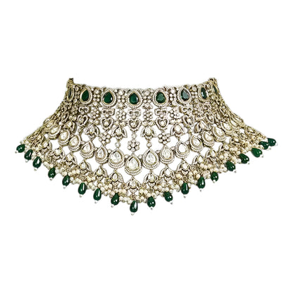 Green Kundan Polki bridal choker necklace set with intricate lattice design, pearl embellishments, green teardrop beads, and matching statement earrings.