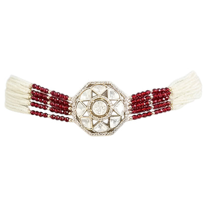 Handcrafted Kundan bracelet with red crystal bead strands and matching round stud earrings on a white background.