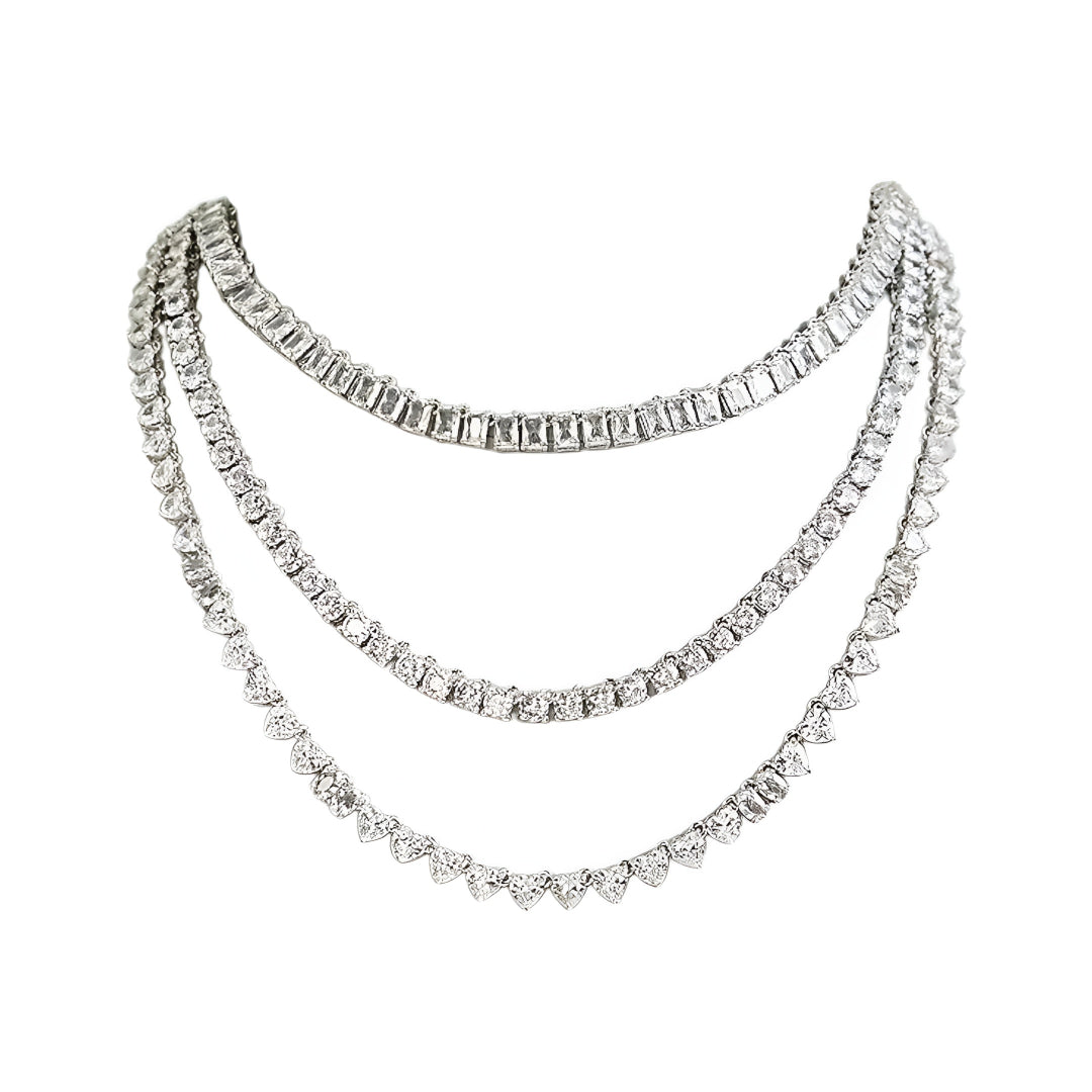 Silver-tone layered crystal necklace with matching drop earrings featuring sparkling clear stones in an elegant bridal jewelry design.
