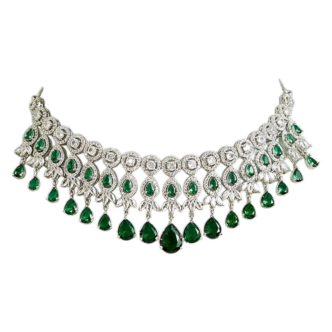 Silver-tone choker necklace and earrings set featuring sparkling clear crystals and emerald green teardrop stones in an elegant bridal jewelry design.