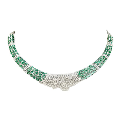 Silver-toned emerald green crystal choker necklace set featuring sparkling stone detailing and matching statement drop earrings on a white background.